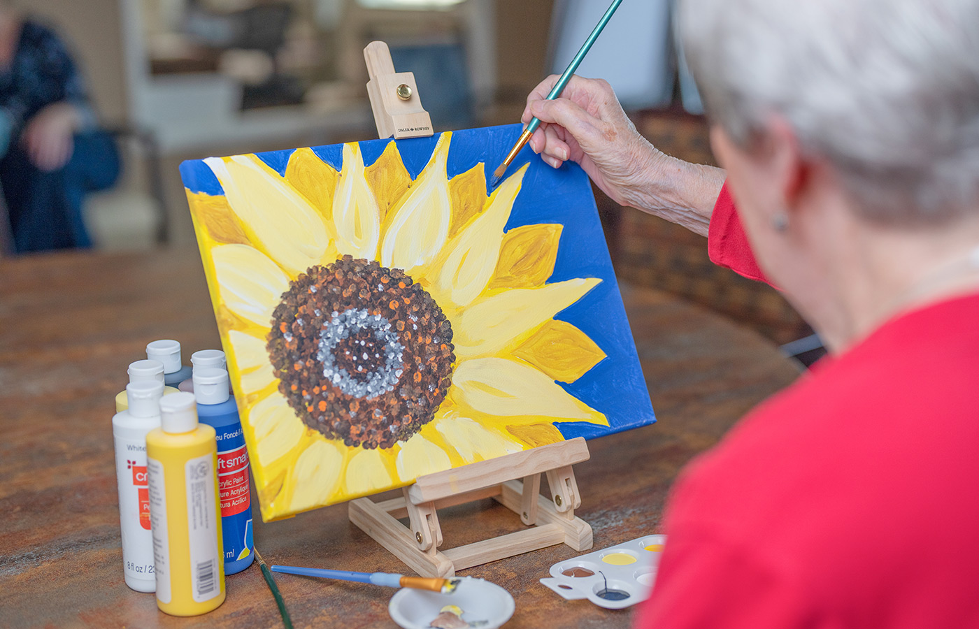 A person painting a flower.