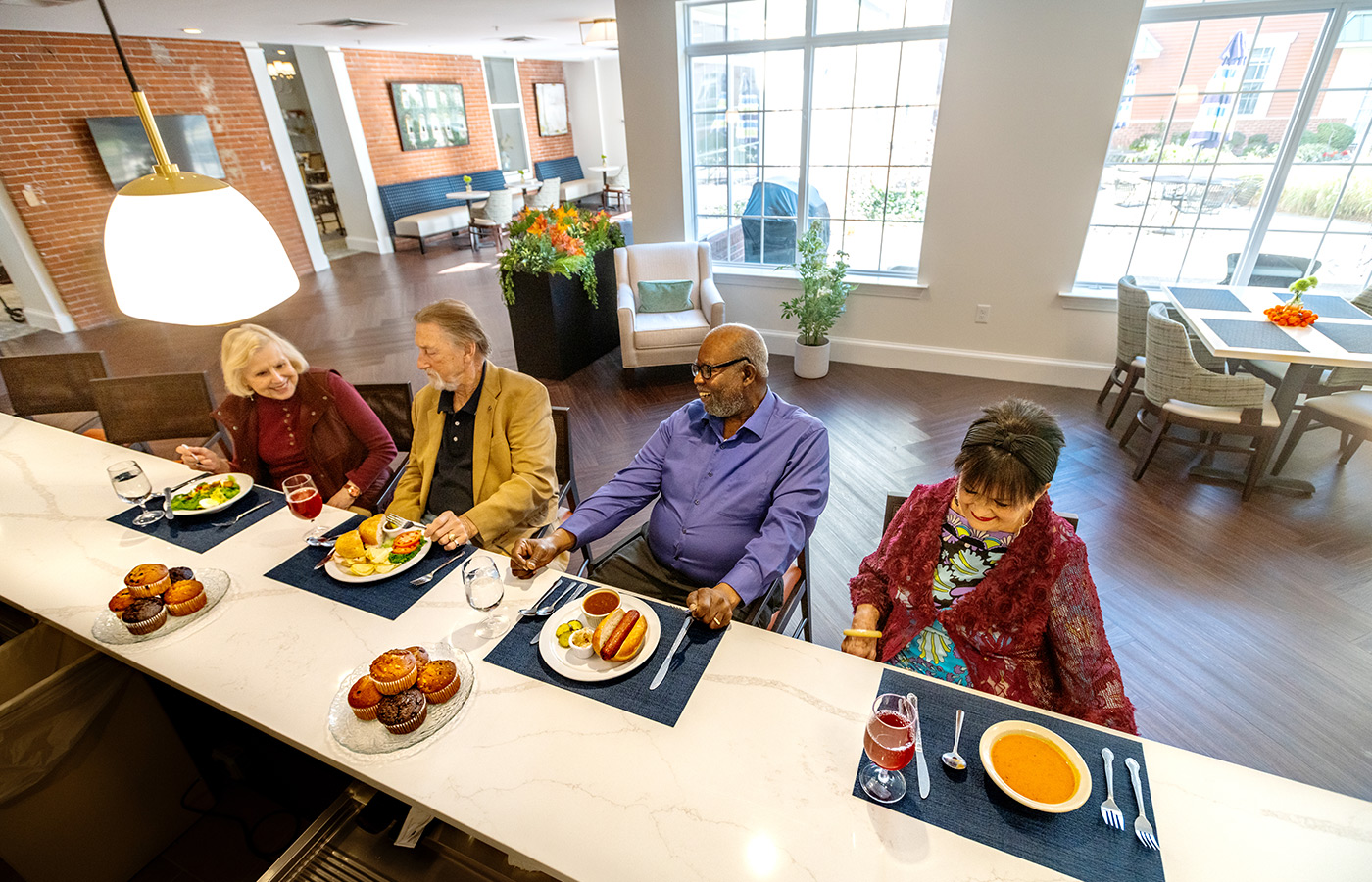 Residents sitting at a bar having their meals together.