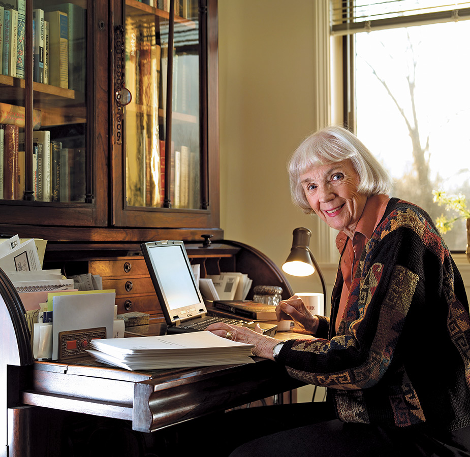 A resident is sitting at a desk on a computer.