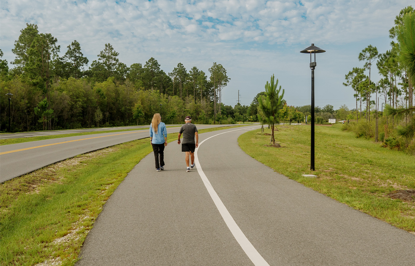 People walking on a path outside.
