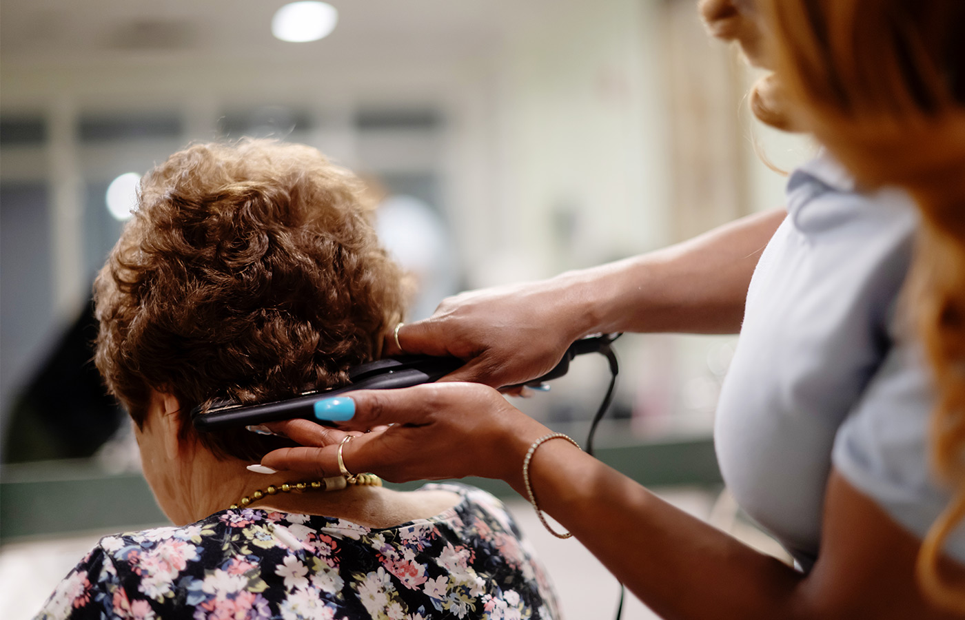A person getting their hair styled.