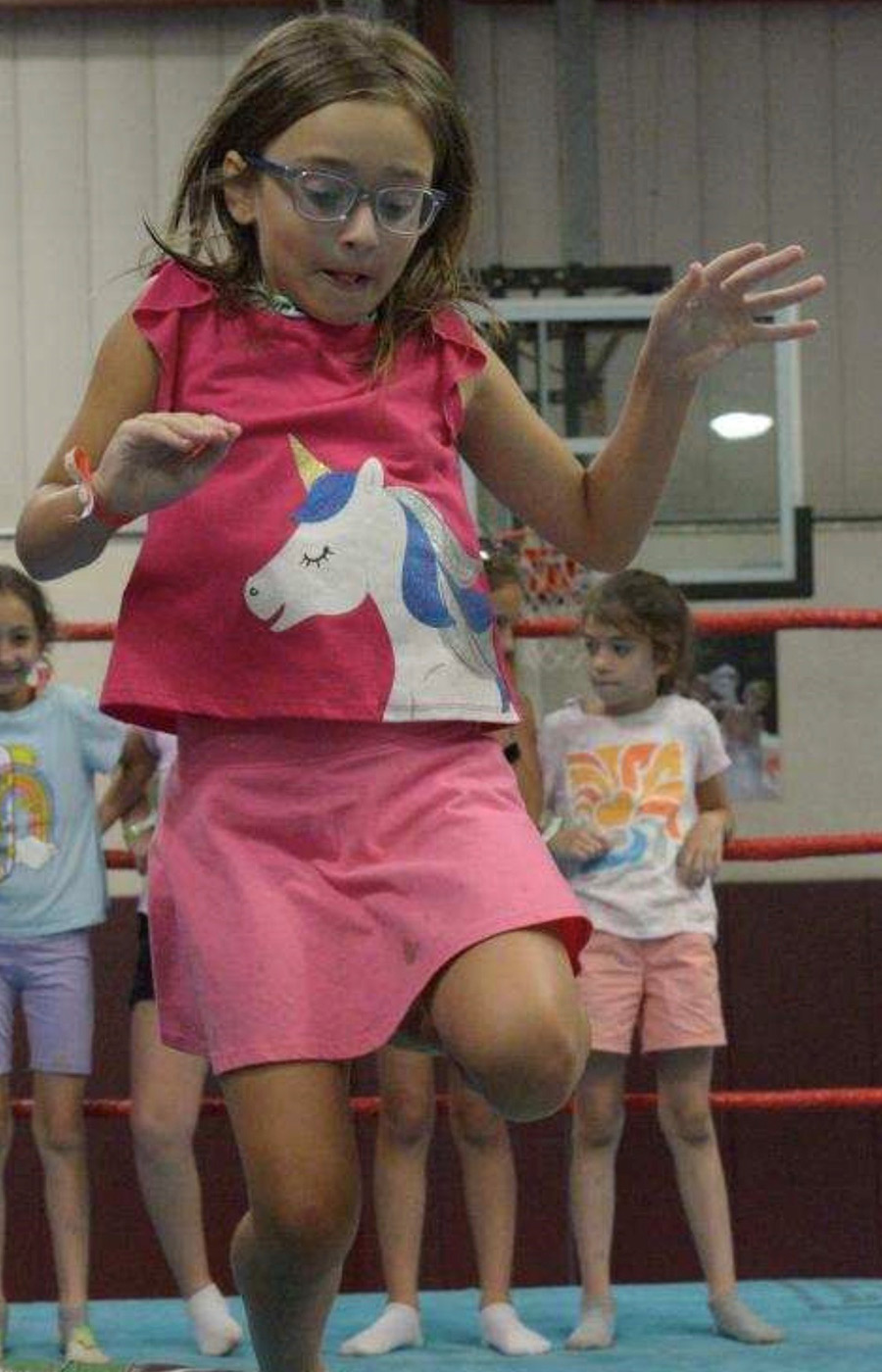 kid in a gym jumping 