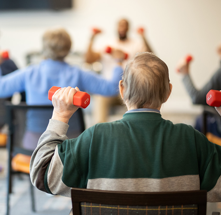 People in a seated fitness class.