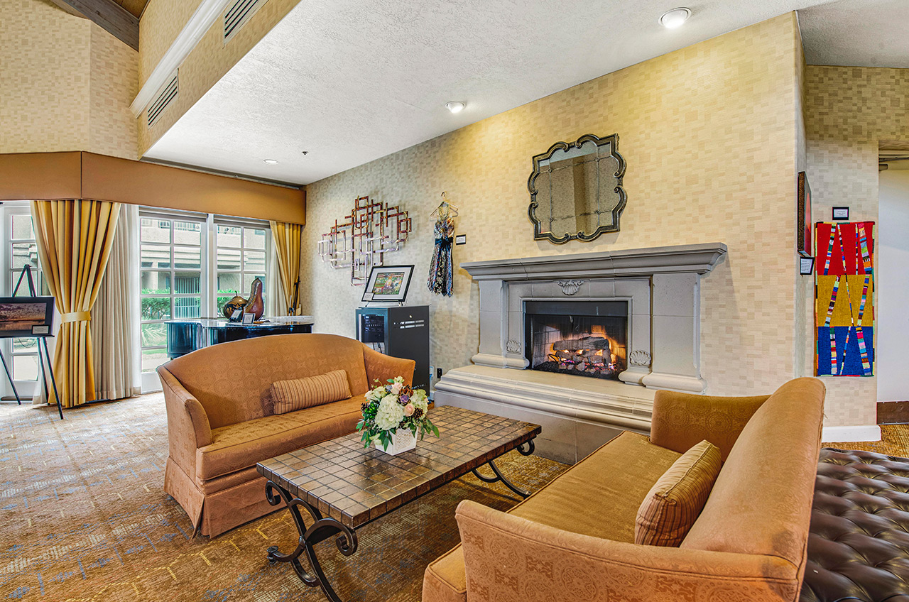 A seating area in front of a fireplace at The Fountains at La Cholla.