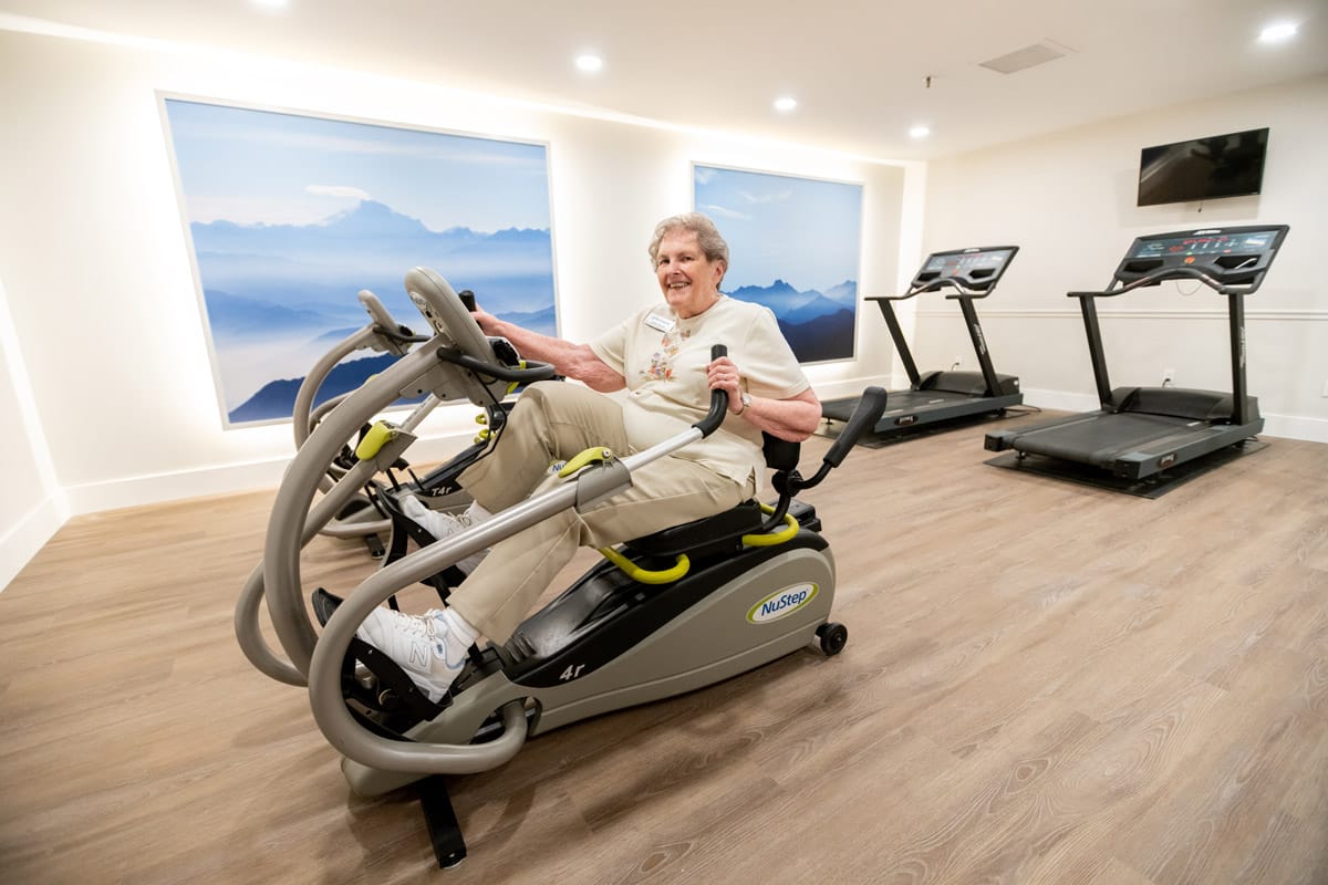 A resident is using a fitness machine.