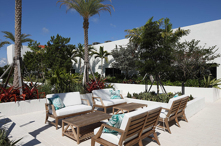 A seating area on the patio by the pool.