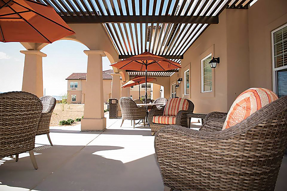 Chairs and umbrellas on the patio at Joshua Springs Senior Living.