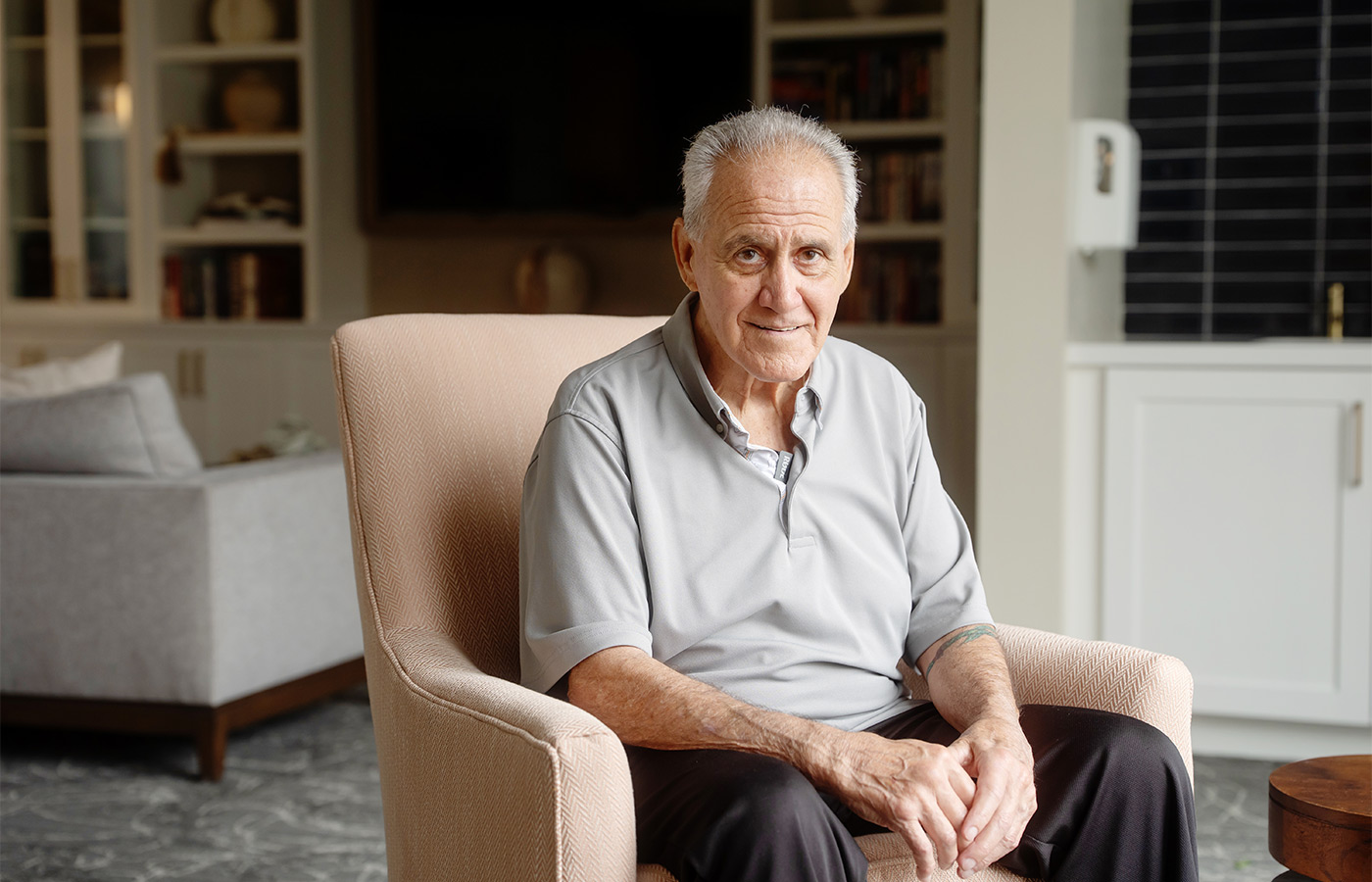 A person sitting and smiling.