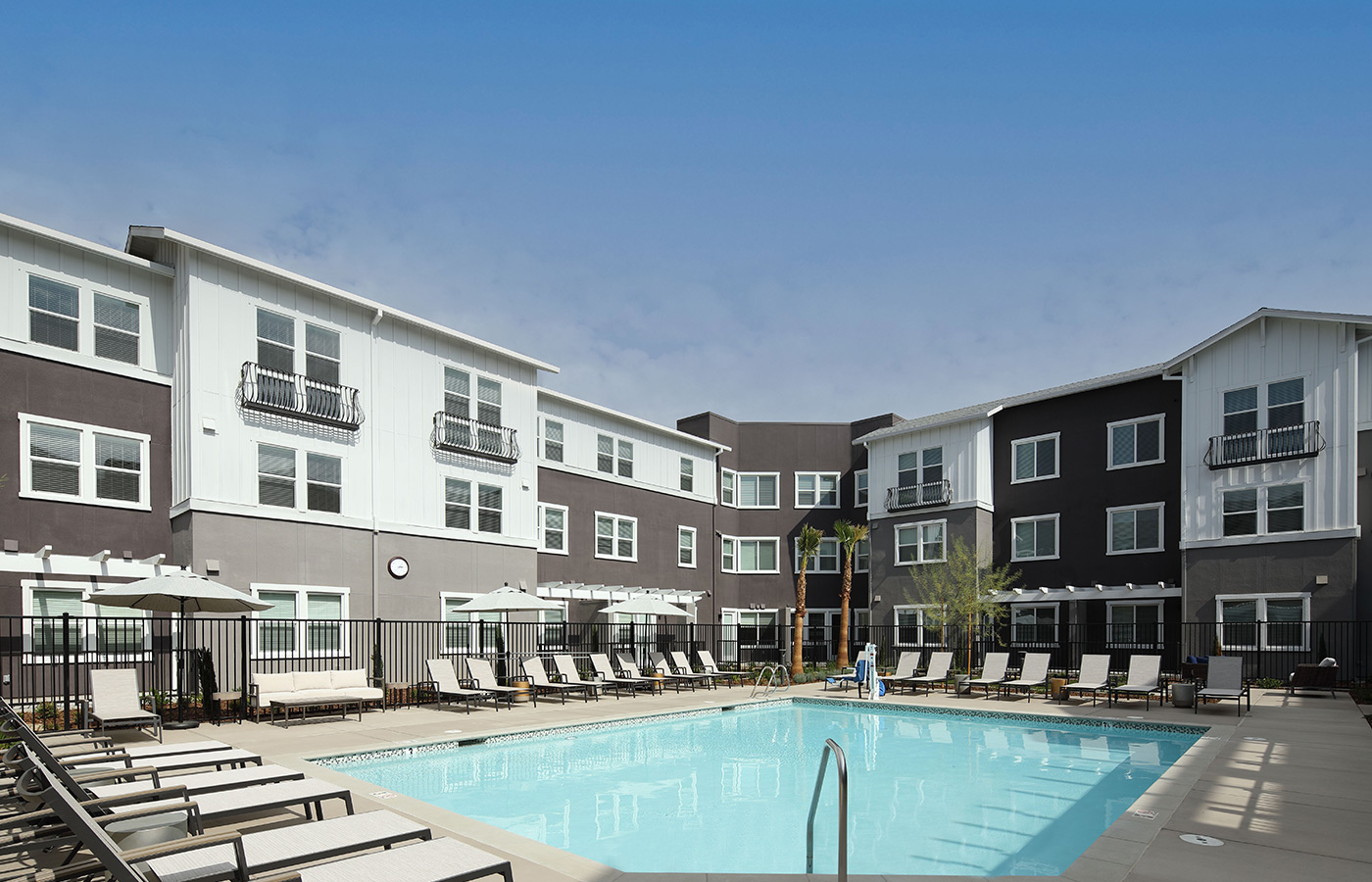 An outdoor pool with lounge seating.