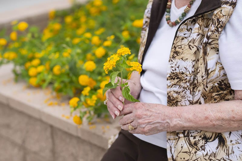 A resident is holding flowers.