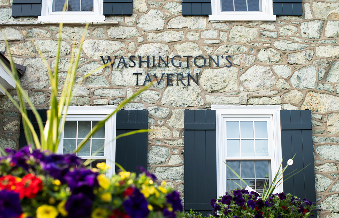 A brick exterior with Washington House Tavern on it.