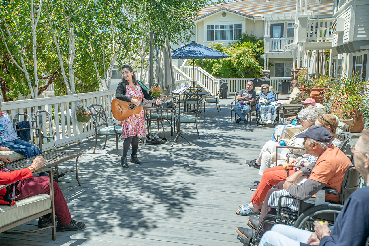 Musician plays guitar for residents.