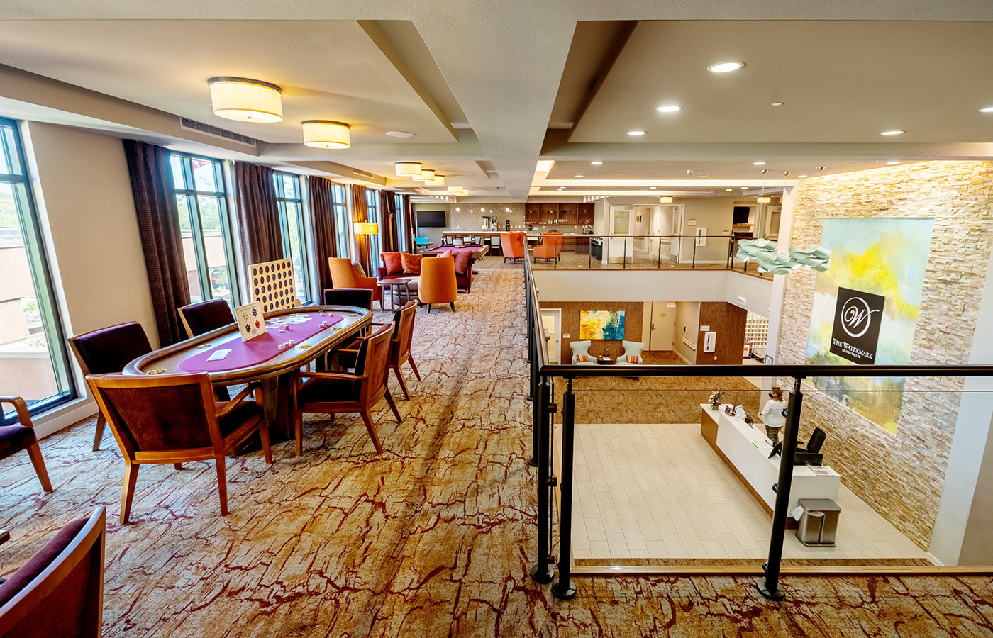 activity room with poker table on floor above lobby