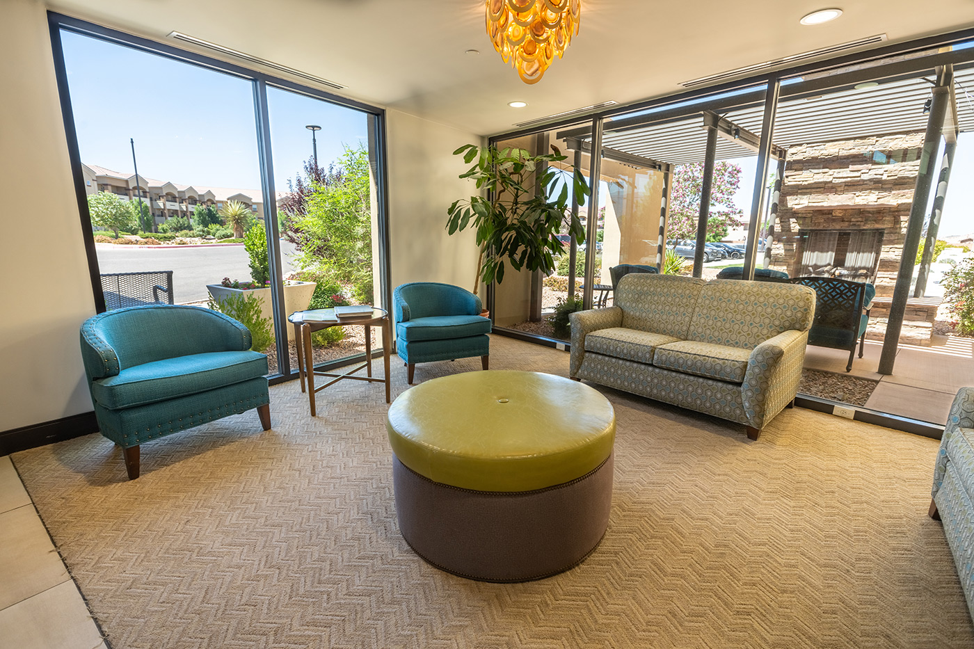 The Watermark at Cherry Hills interior lounge seating with round green ottoman.