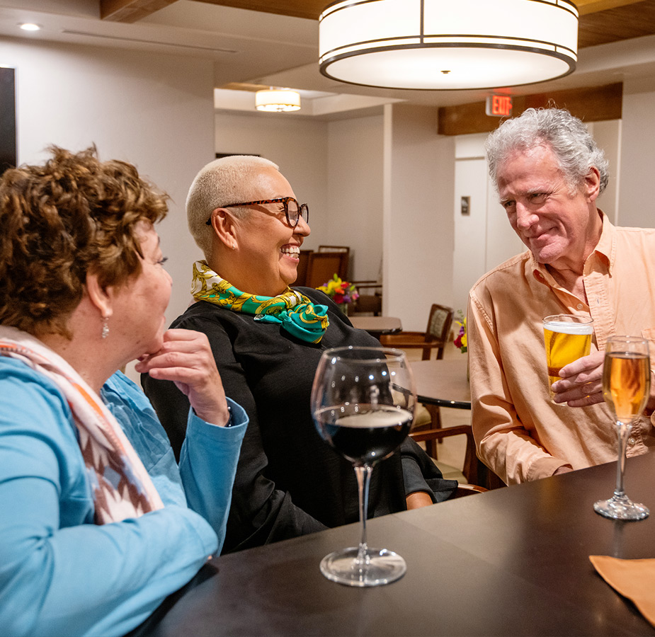 Residents are sitting at a bar chatting.