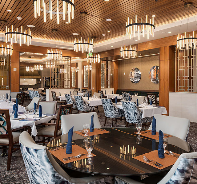 A beautiful dining room with large chandeliers.