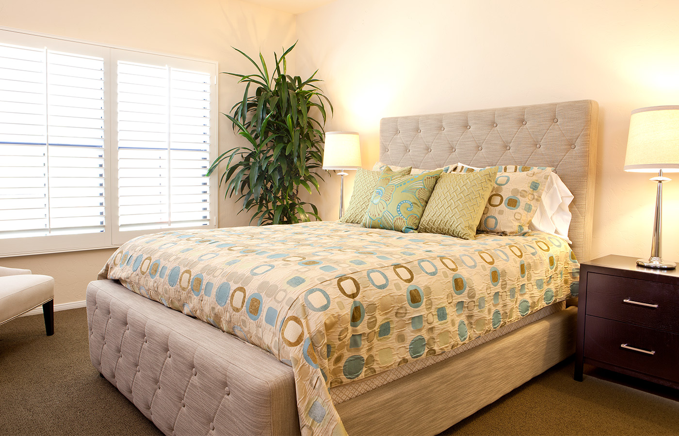 Big bed near window and plant.