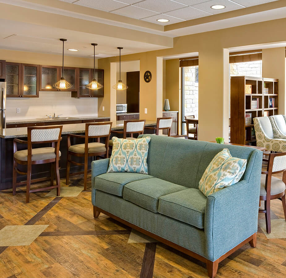 Seating area with blue sofa and pillows.