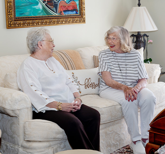 Two people sitting on a couch.