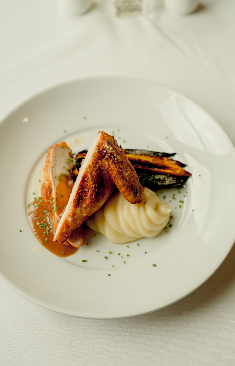 Chicken with mashed potatoes on a plate.