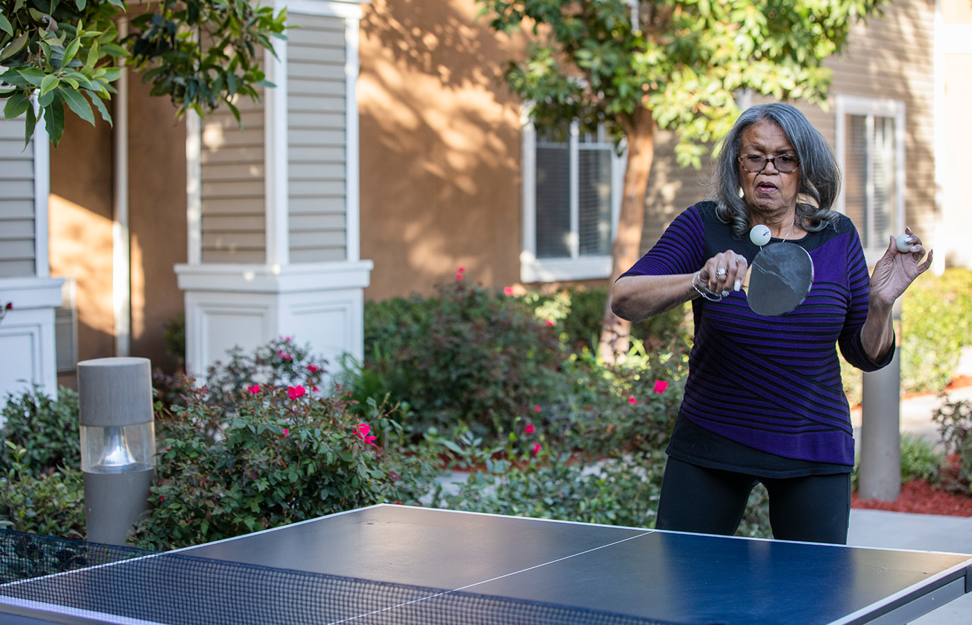 A resident is playing table tennis.