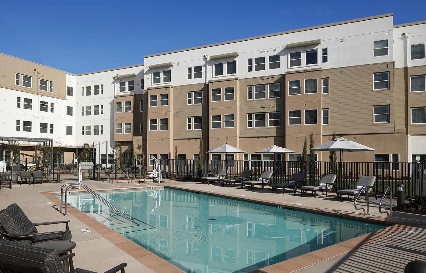 An outdoor pool with lounge chairs.