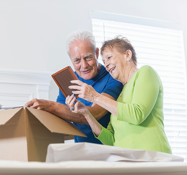 People packing a box.