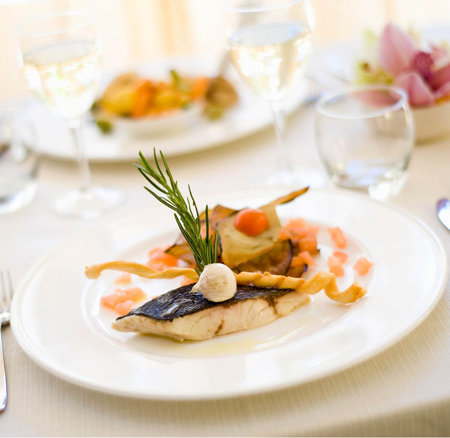 A dinner plate with fish and vegetables.