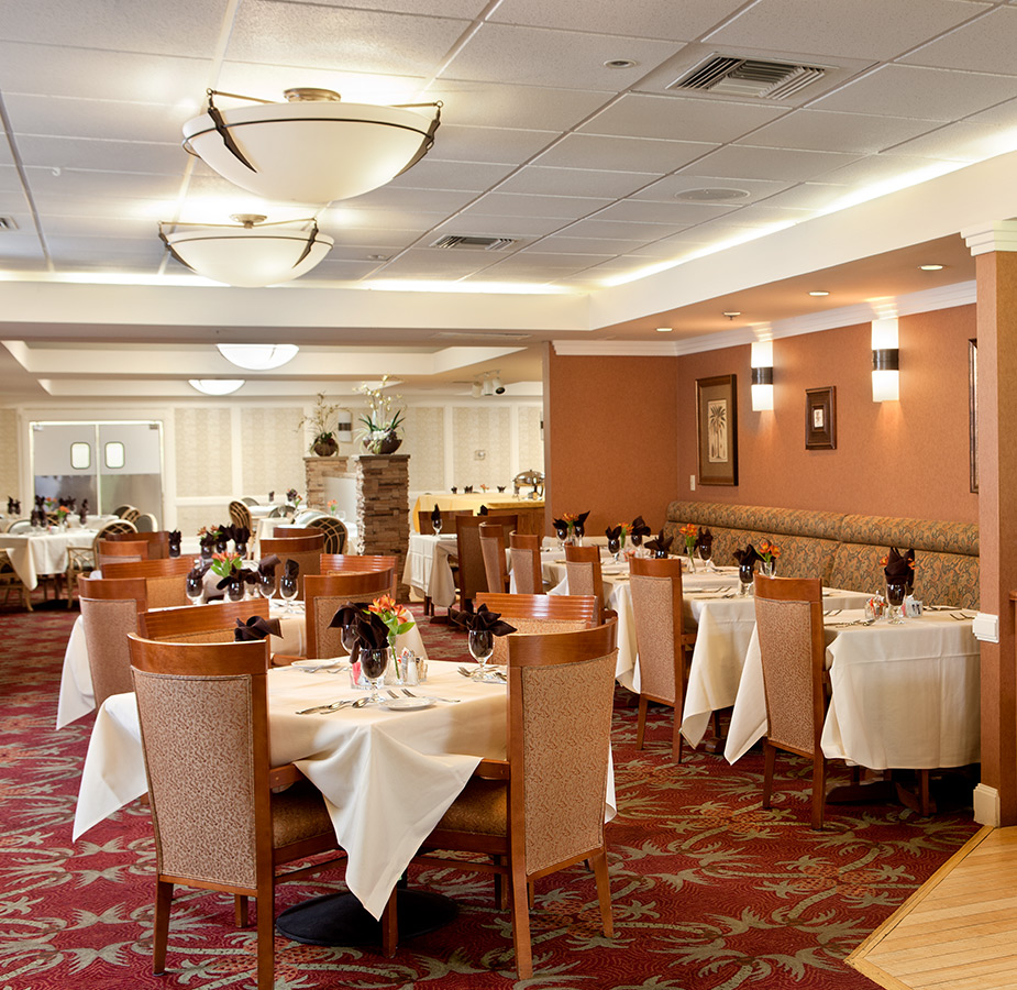 dining room with white table cloths and set tables