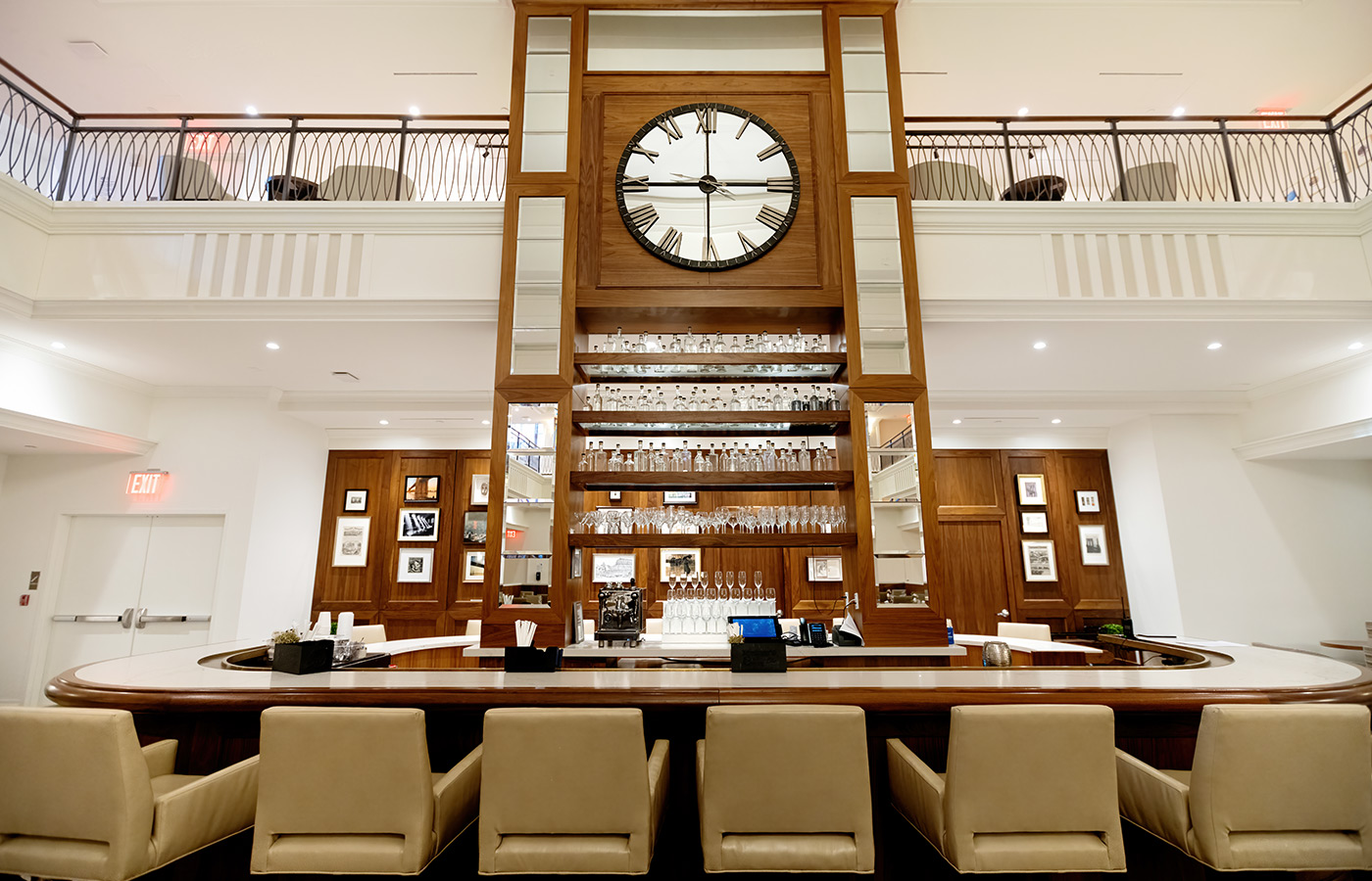The bar of the main dining room with a giant clock above.