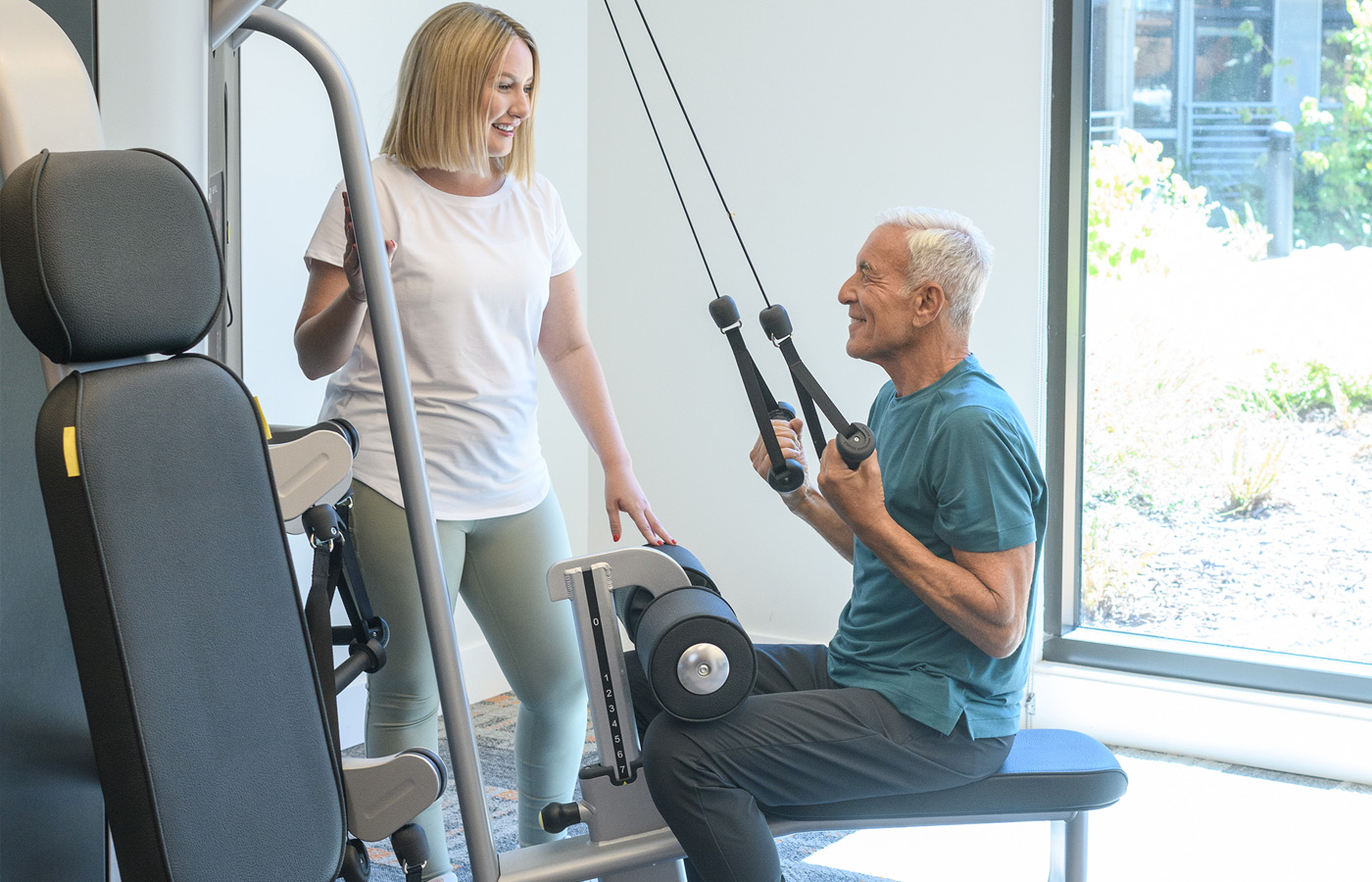 A resident is using a fitness machine.