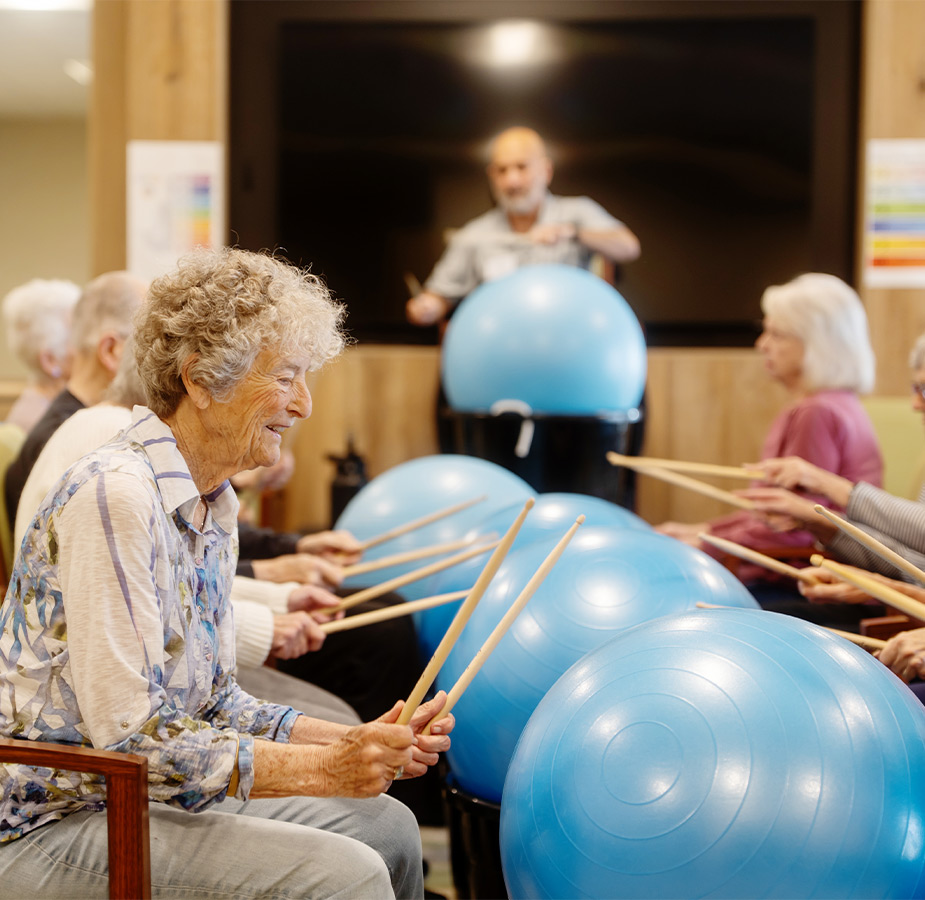 People drumming on large rubber balls.
