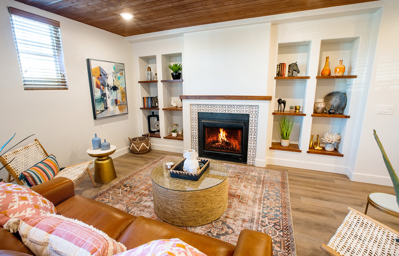 Fully furnished living room with couch and fireplace.