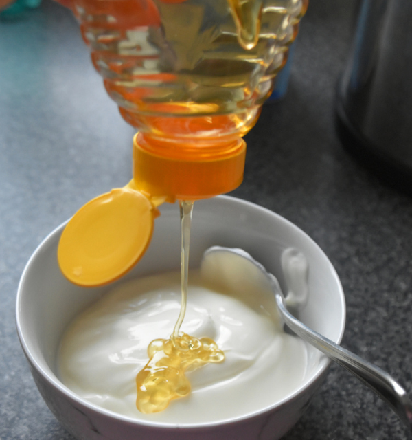 Plain yogurt with honey drizzled on it.