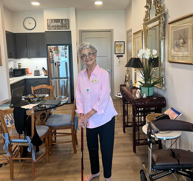 A person standing with a cane.