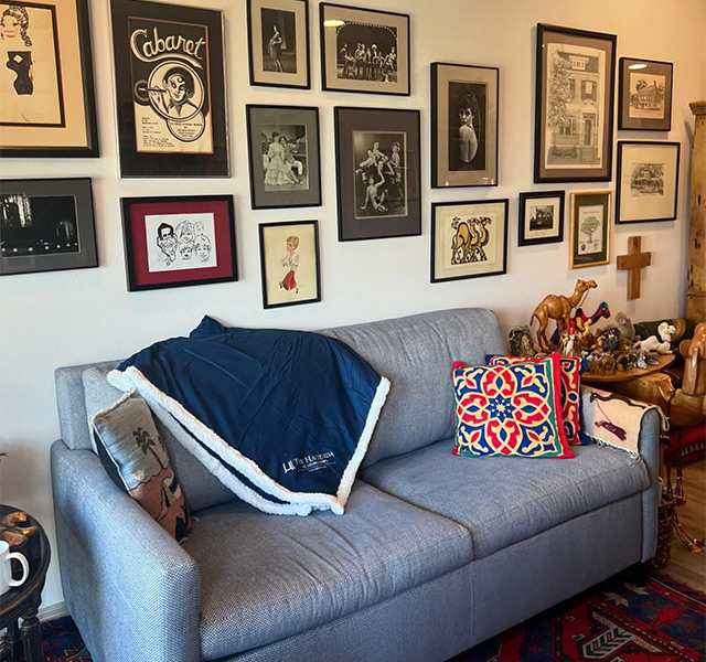 A couch with a blanket on it.