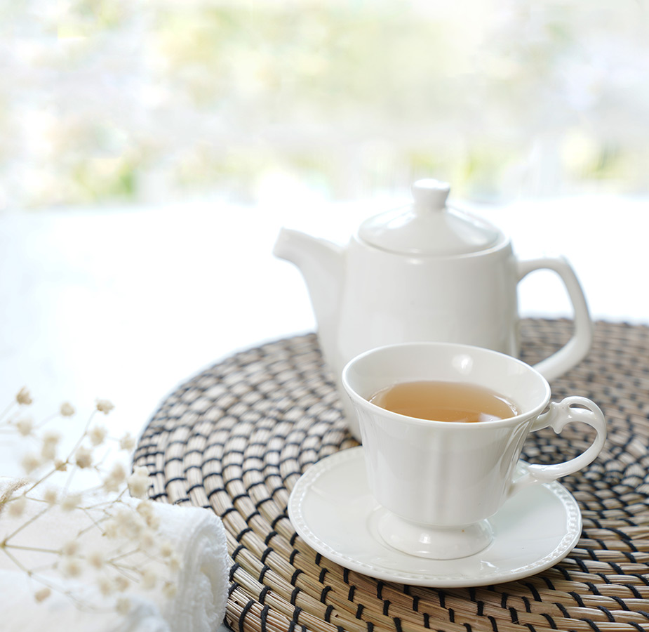 A tea set on a table outside.
