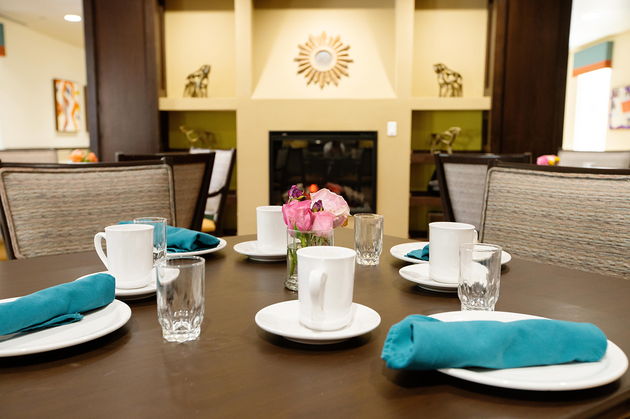 Plates and coffee cups on table in dining room.