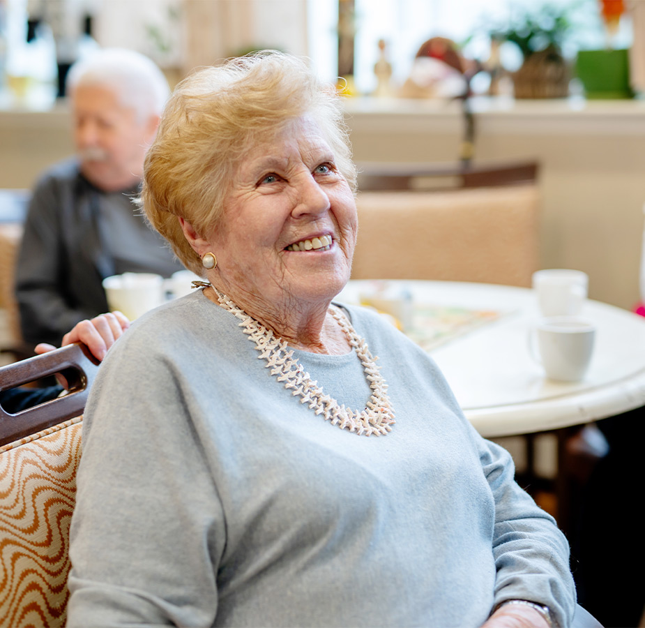 A person sitting and smiling.
