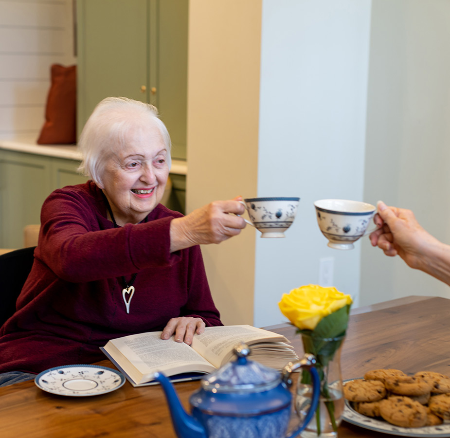 A person toasting with tea cups.