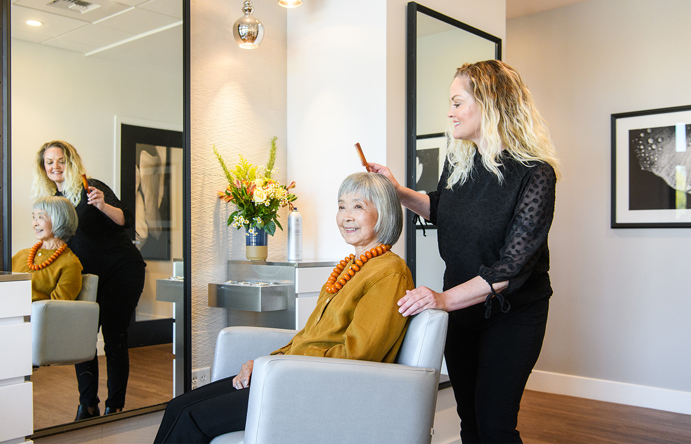 A resident is having their hair done at the salon.
