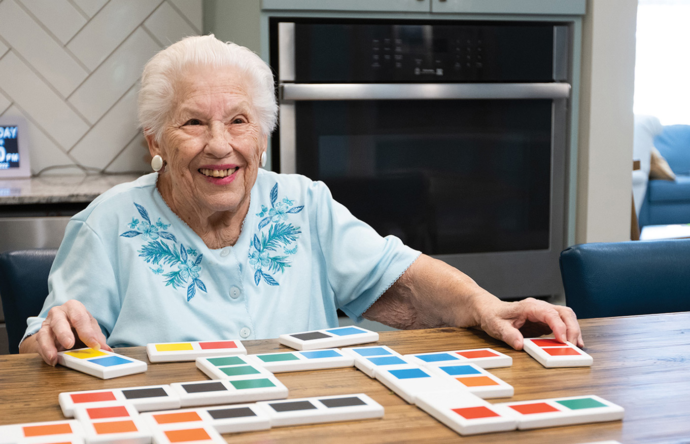 Resident smiling. while working on an activity.