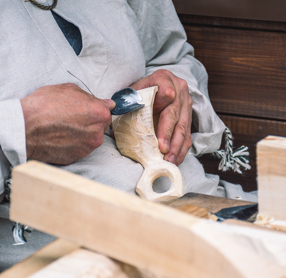 Resident woodworking a sculpture.