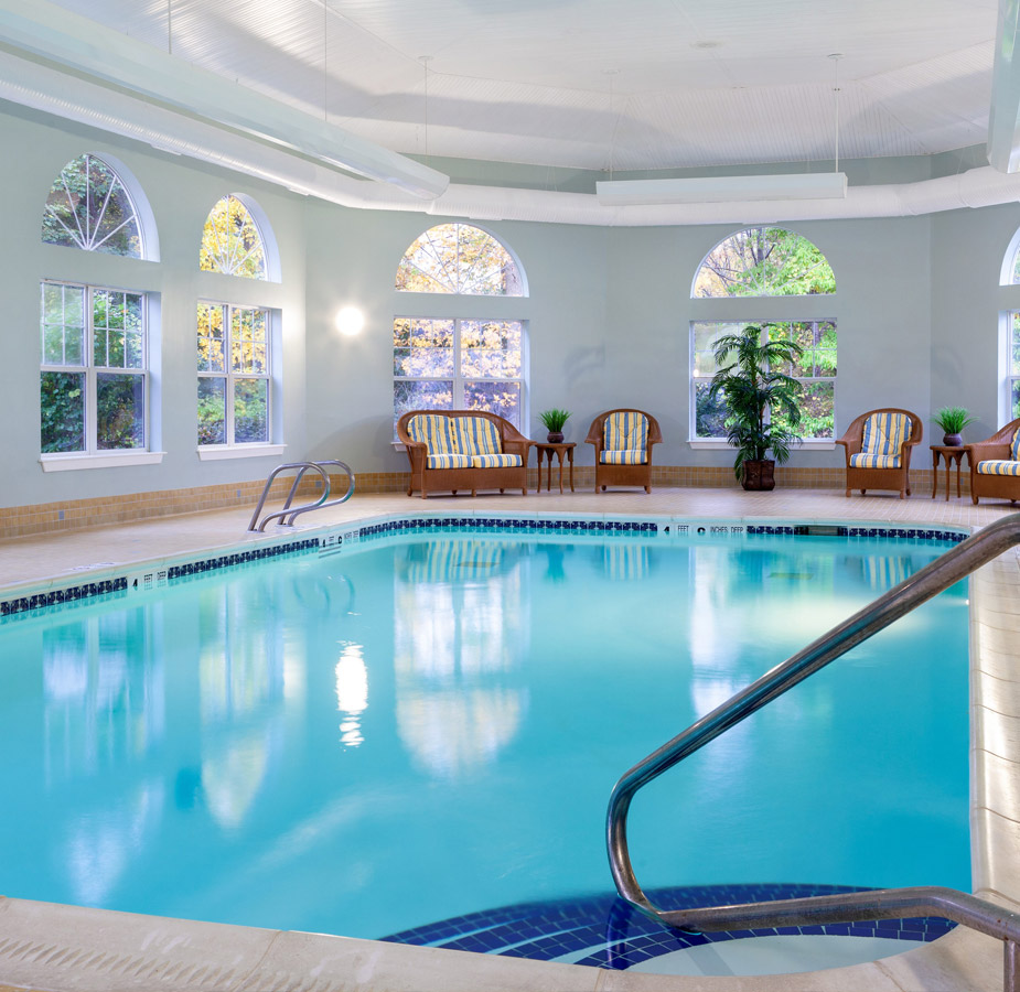 Indoor pool with seating area.