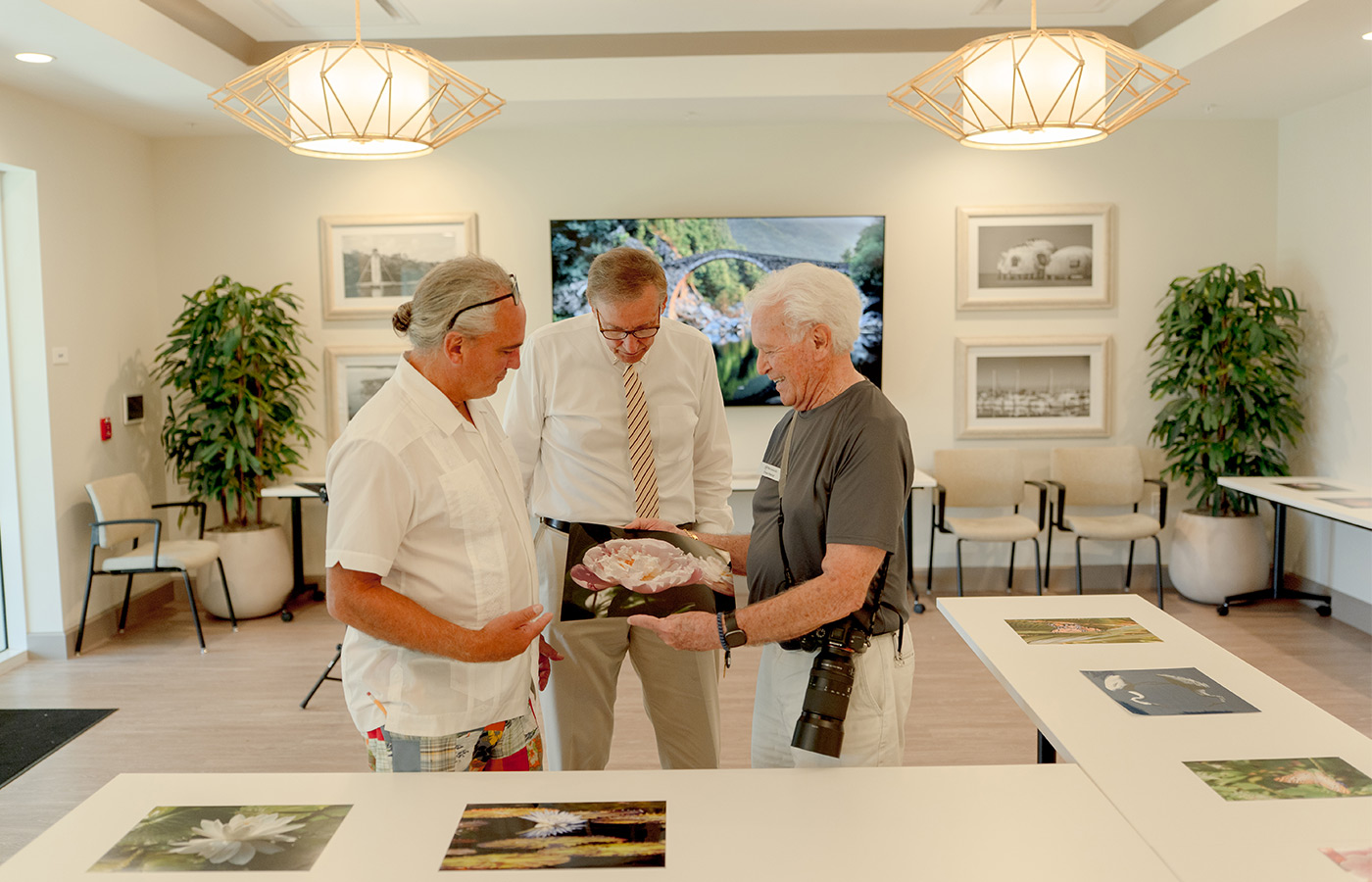 People looking at prints in a gallery.