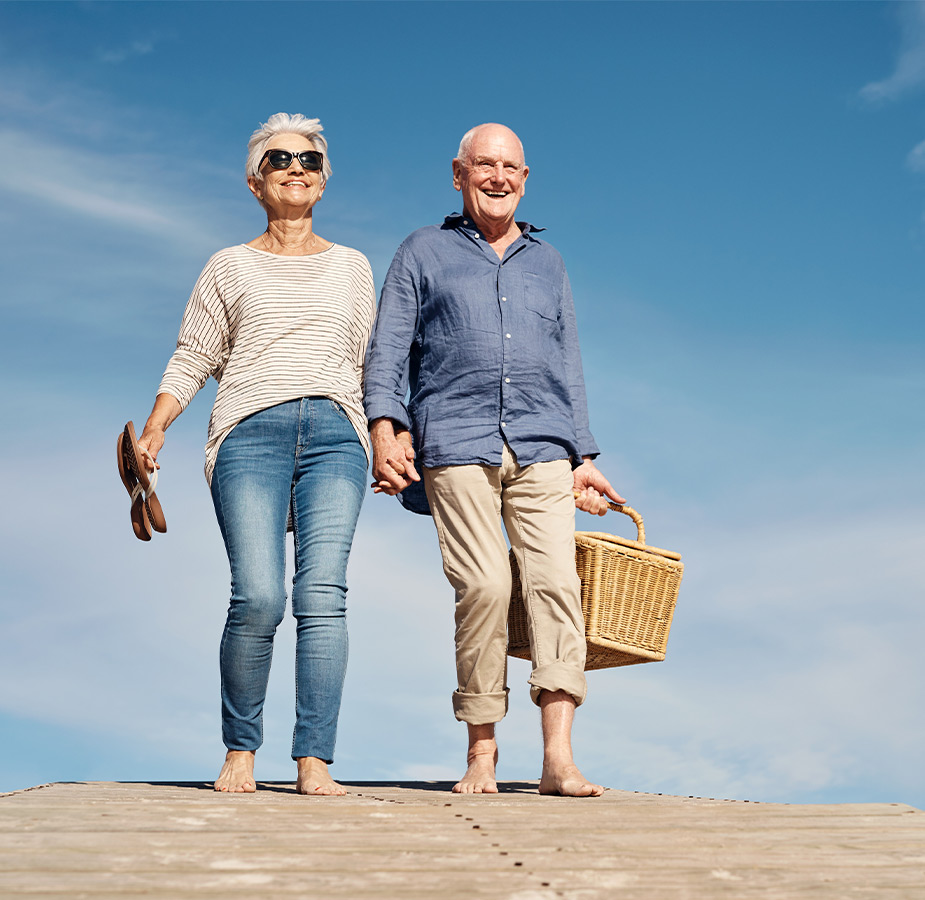 Two people walking on the beach.