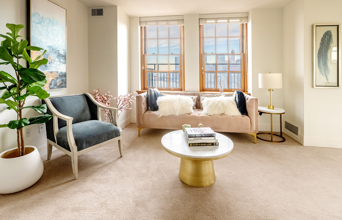 The terrace apartment living room with a mauve couch and city views from the window.