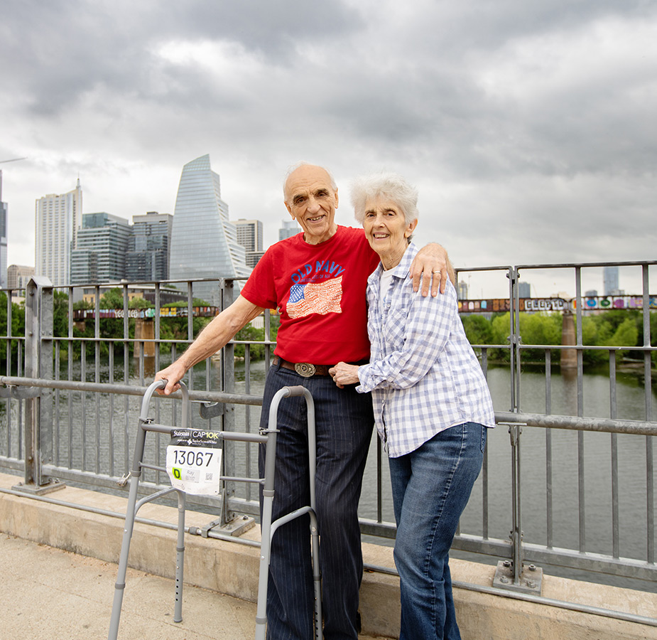 A married couple on the bridge during an outing.
