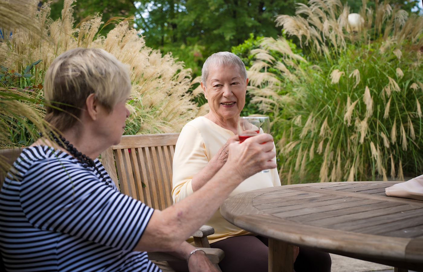 Two people having drinks on the patio.