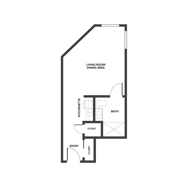 An assisted living studio suite floor plan with an open living/bedroom space and kitchenette.